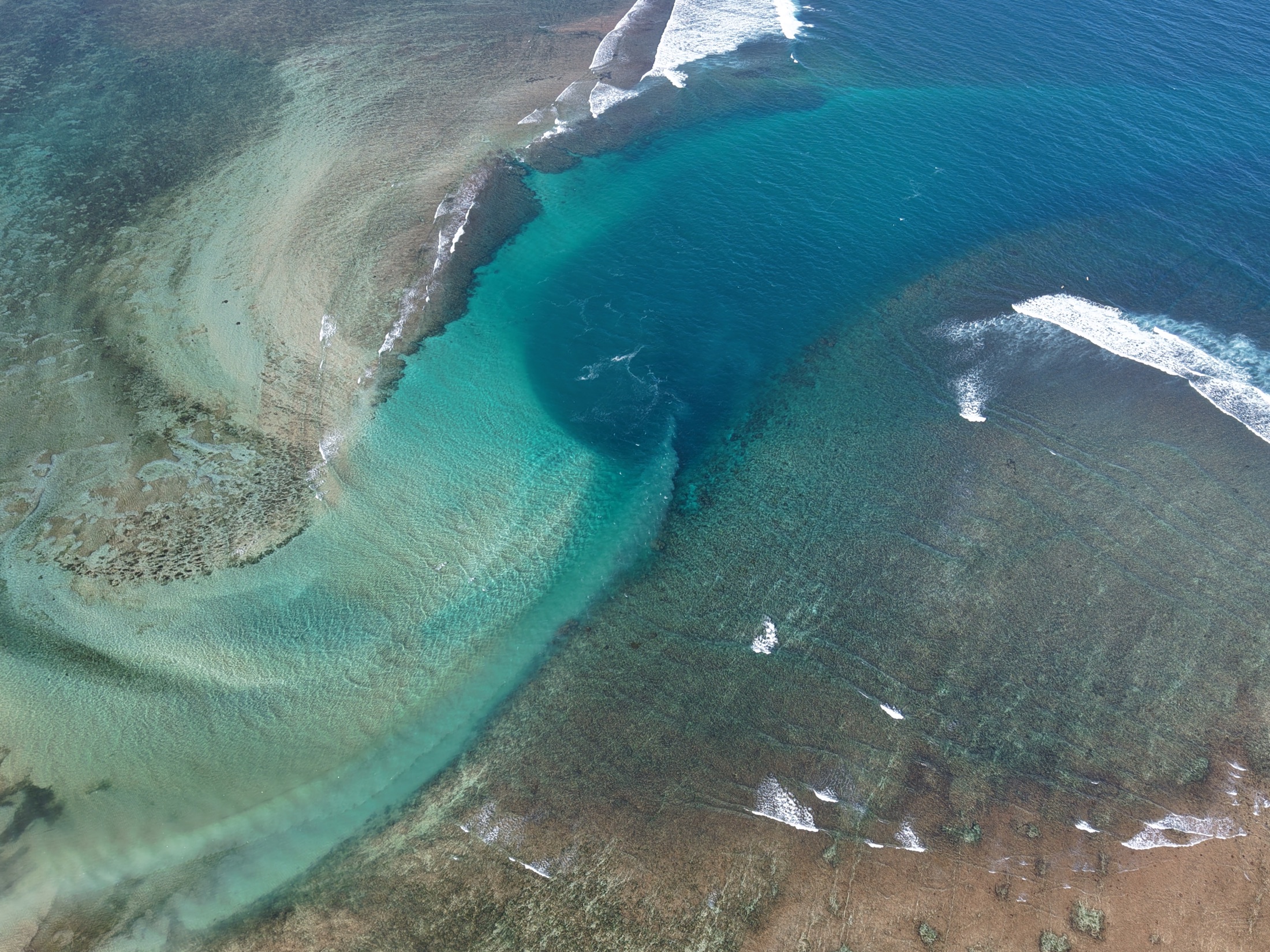 Reef, shallow water, and wave patterns along the Lombok coast